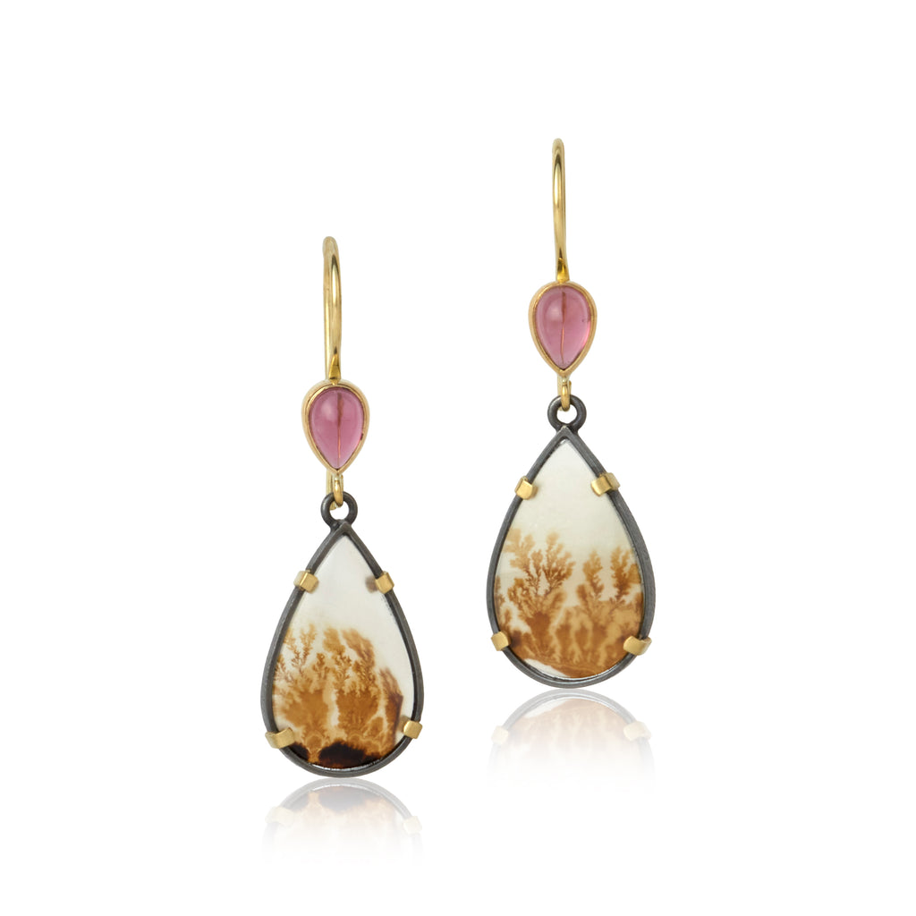 shows a pair of earrings with pear cut garnet cabochons on top and larger pear cut dendritic agate drops on the bottom, set in 18k gold and oxidized sterling silver