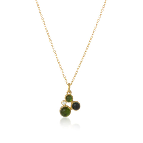 necklace with three round green tourmaline cabochons and one diamond set in gold on a gold chain