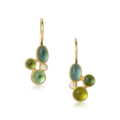 Shows a pair of earrings, each with three teal or green tourmalines and one diamond, set in yellow gold with gold french wires