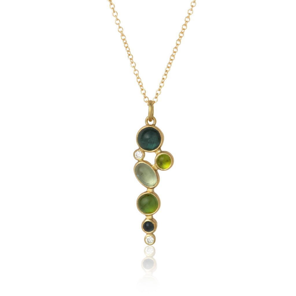 shows a pendant with 5 green and teal tourmaline cabochons and two tiny diamonds bezel set in yellow gold on a yellow gold cable chain